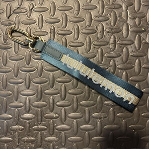 Lululemon teal and gold never lost keychain 

NWOT